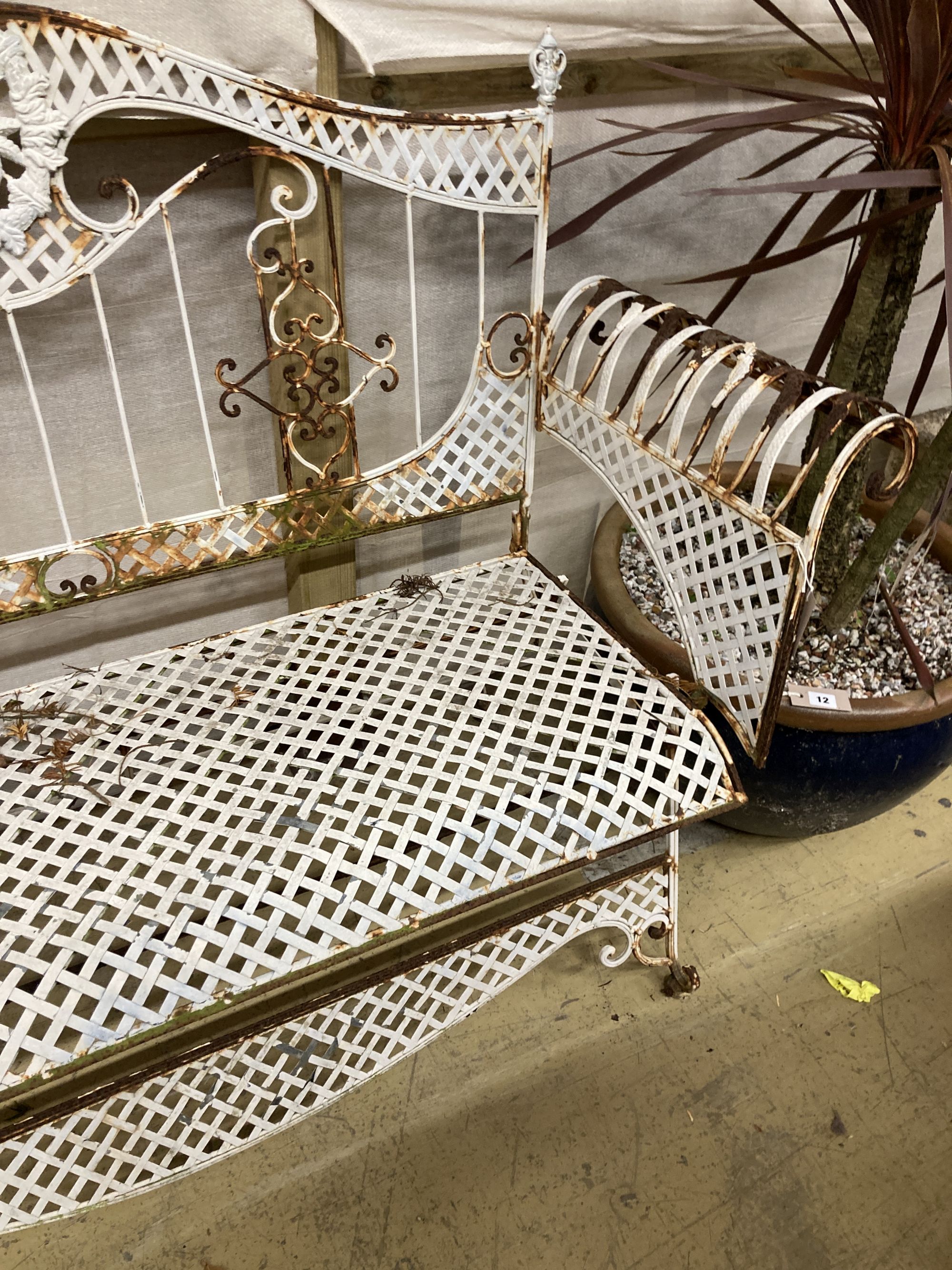 A painted wrought iron garden bench, length 138cm, depth 50cm, height 102cm